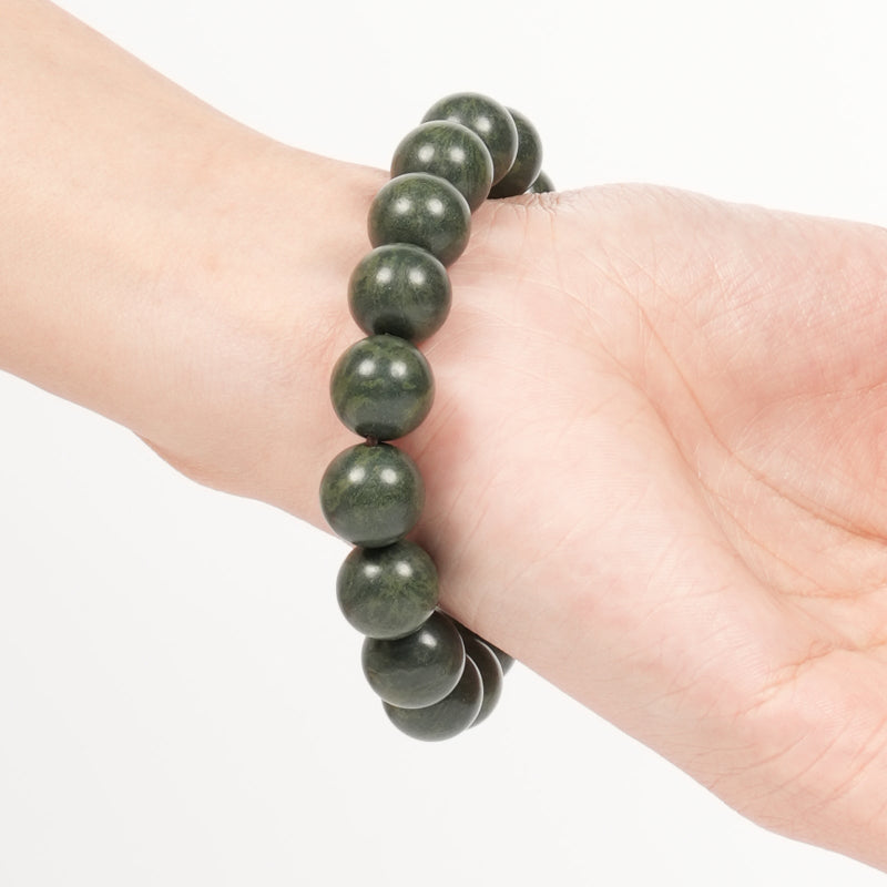 Green beaded bracelet on a person&