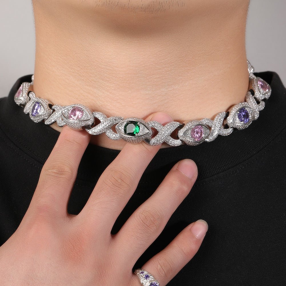 Elegant diamond necklace with colored gemstones worn by a person against a neutral background