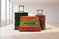 Four suitcases of different colors stacked on a white background