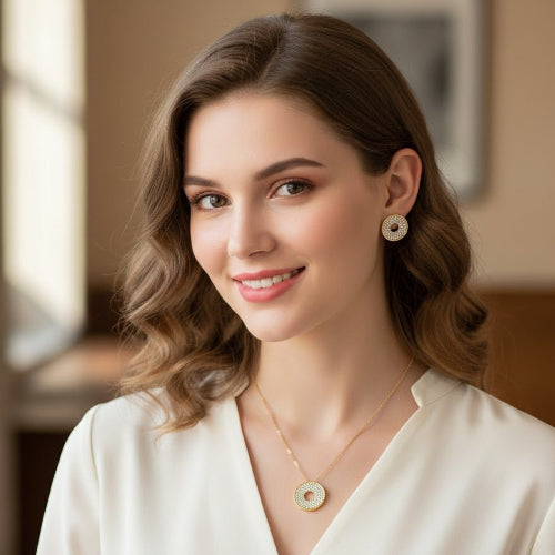 Woman wearing gold jewelry with a blurred indoor background